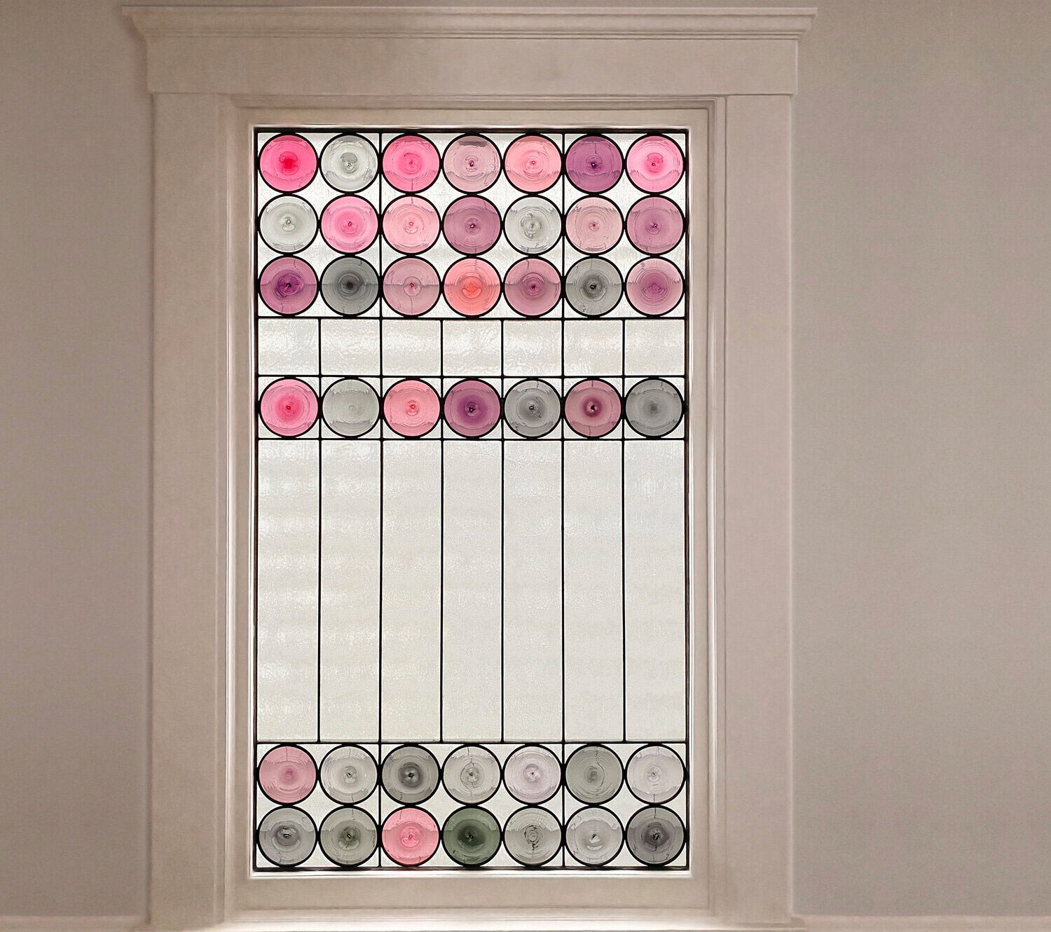 Rondel lucent stained glass window in window frame